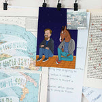 There are a lot of notes, posters, postcards hanging on the wall. One of them is GetAnimized drawing in Bojack Horseman style. In the postcard you can see a guy sitting on the roof with Bojack. The sky is clear and dark, with beautiful stars visible.